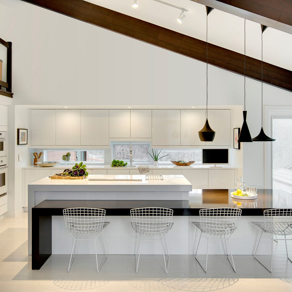 A sleek, modern white kitchen design with both Cambria Black as well as White Cliff quartz countertops