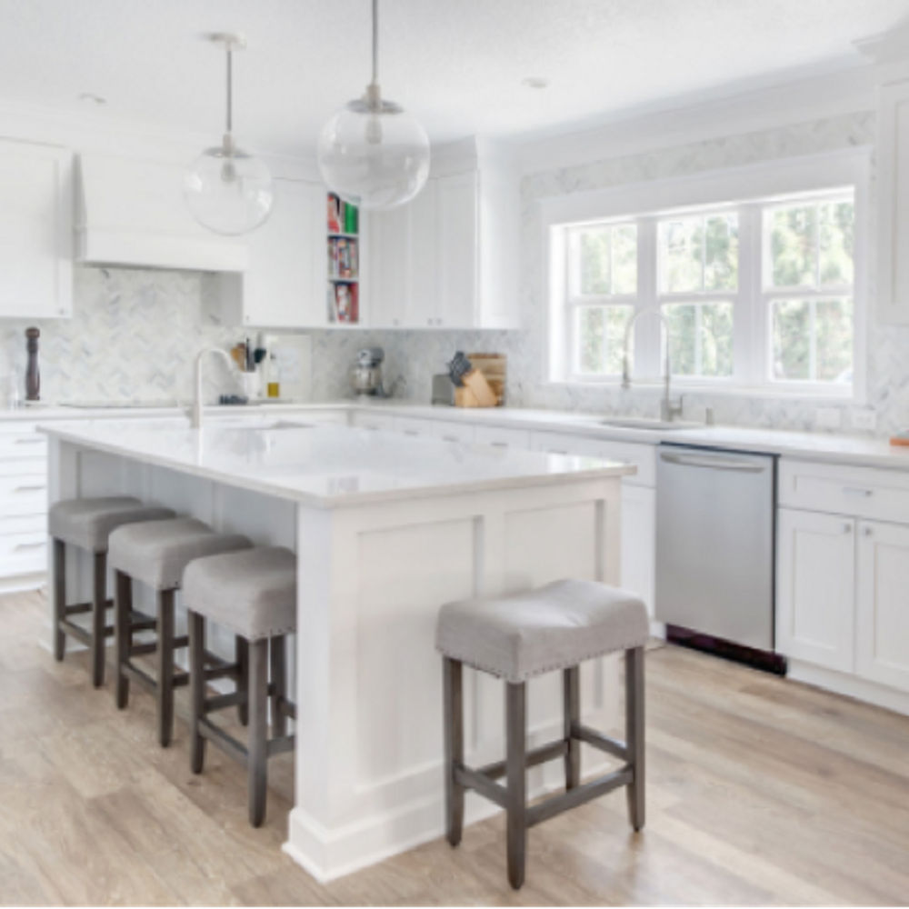 Kitchen featuring a new layout with Cambria Torquay quartz countertops and a large kitchen window.