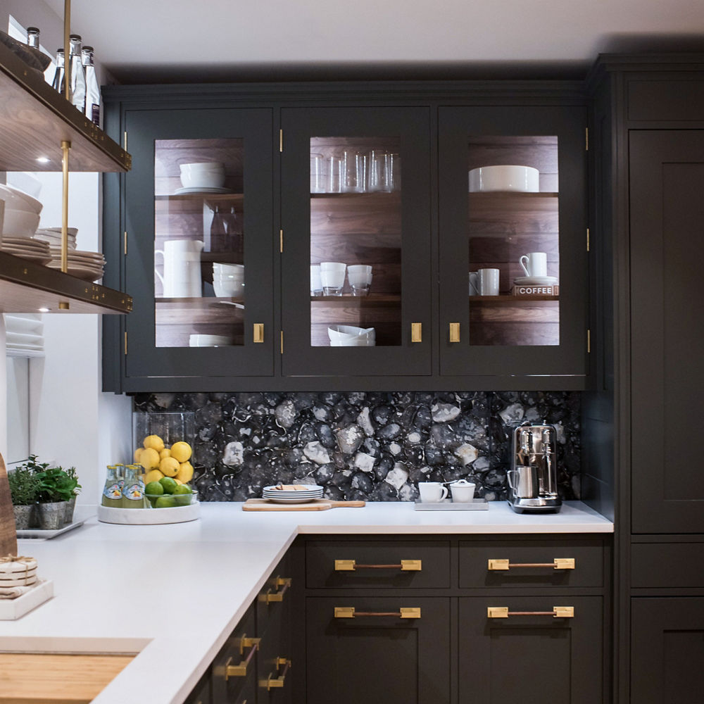 An elegant kitchen with display style cabinetry and Cambria White Cliff quartz countertops