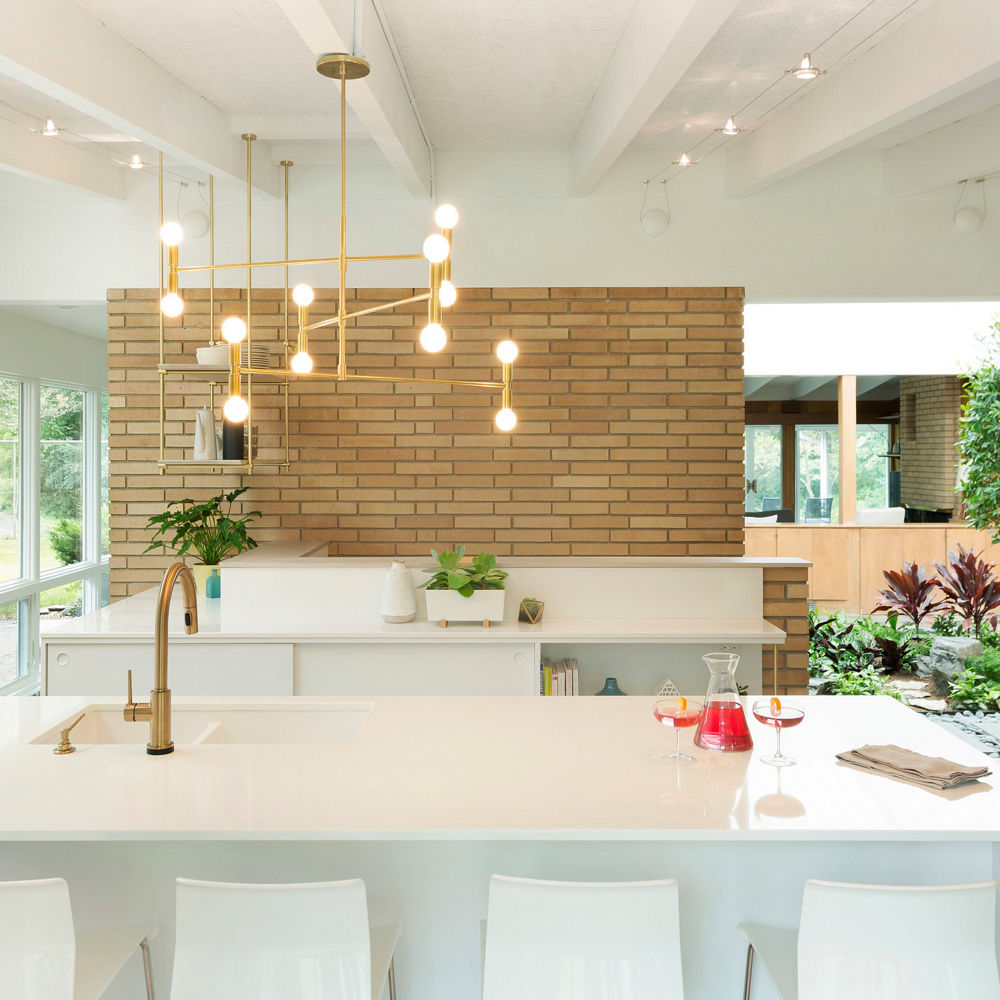 A modern white and brick kitchen with Cambria countertops