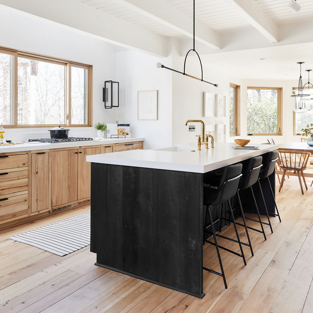 An open layout kitchen with Cambria White Cliff Matte countertops