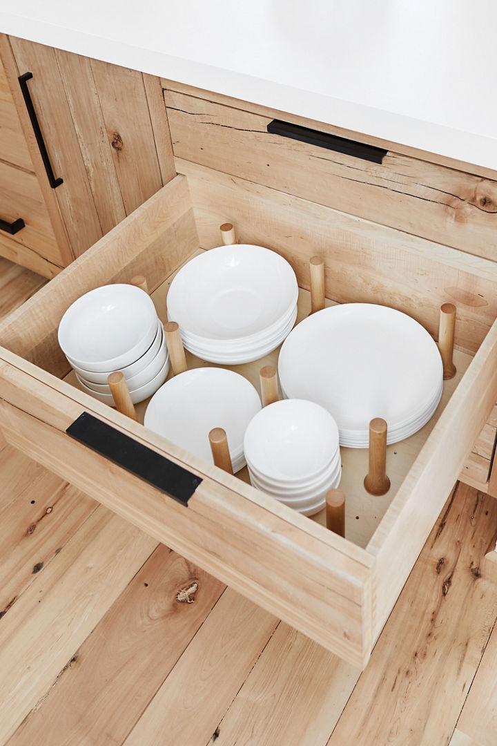 Cambria White Cliff Matte quartz kitchen countertops featuring open drawer with plates and bowls