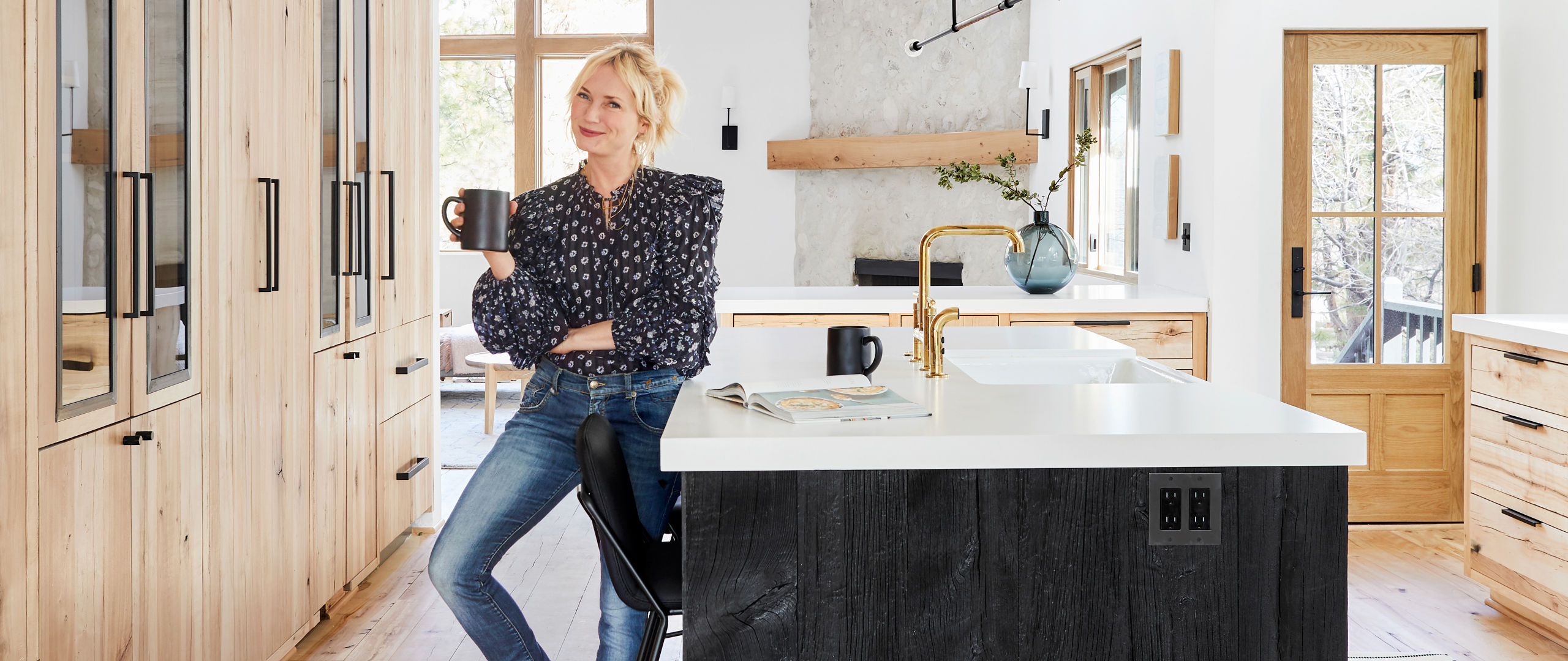 Emily Henderson standing in front of her newly rennovated mountain house featuring Cambria quartz countertops