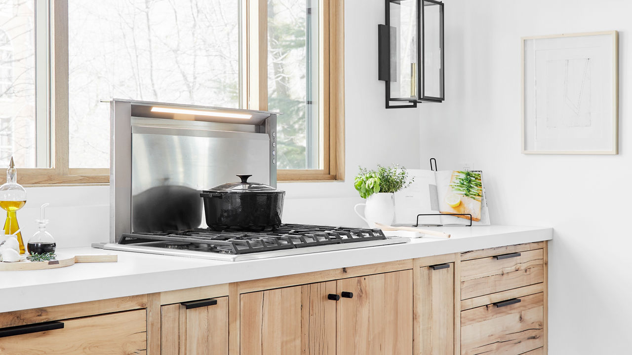 Natural light streams in through custom Marvin windows, with Cambria quartz countertops in a gorgeous mountain kitchen.