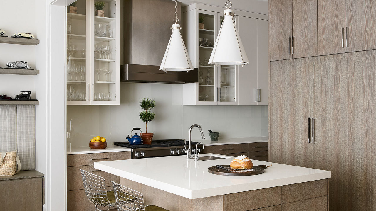 A light kitchen with light brown cabinets and Whitehall quartz countertops