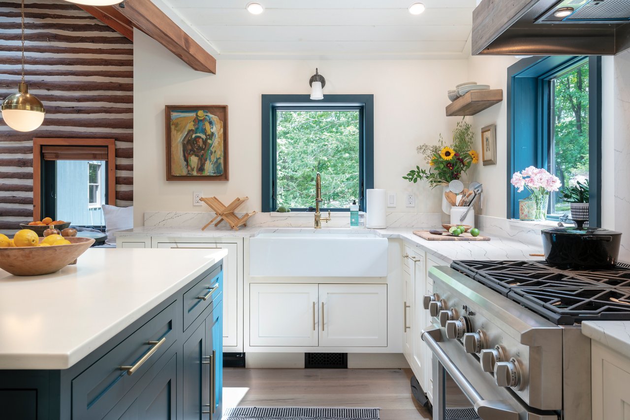 Kitchen featuring a blend of white blue cabinetry with white countertops.