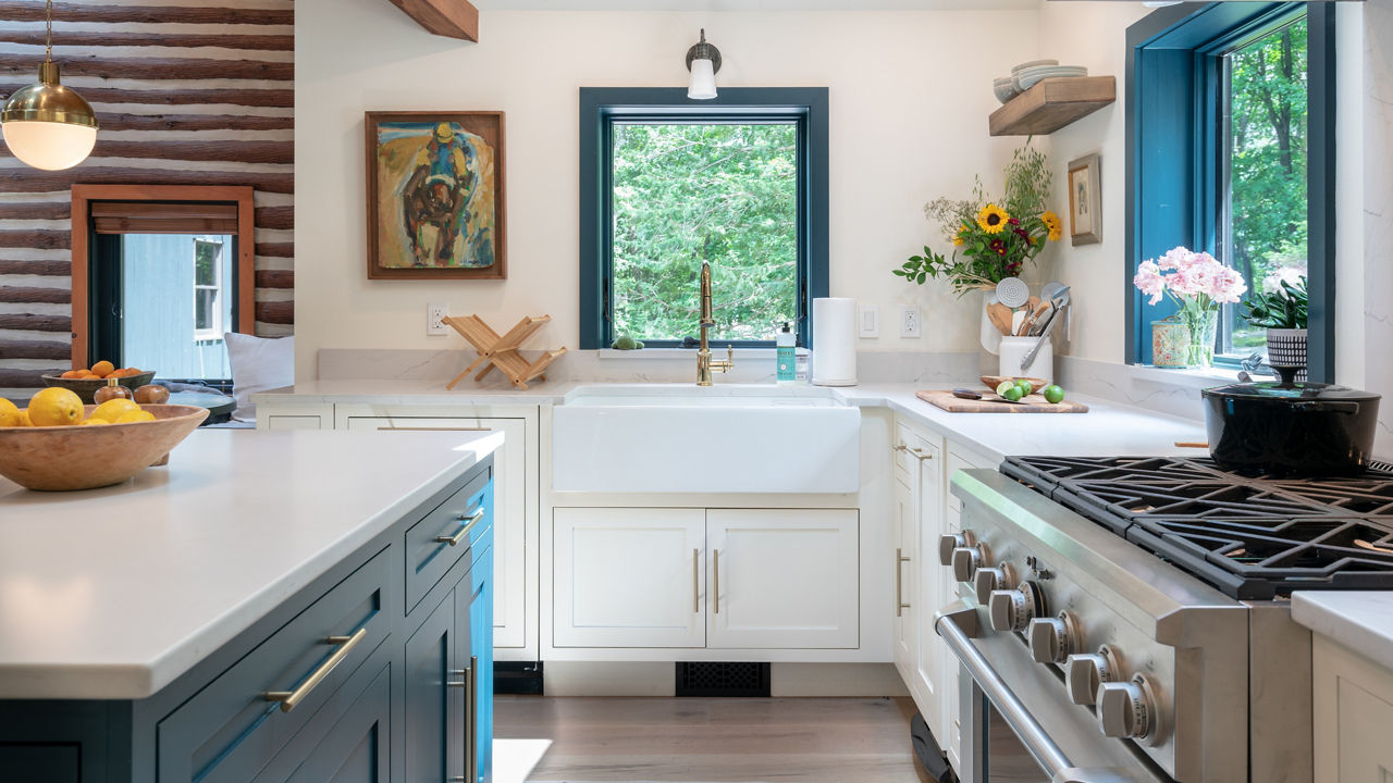 Kitchen featuring a blend of white blue cabinetry with white countertops.