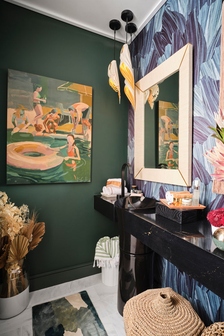 a bathroom with a black quartz vanity, bold mural, green walls, and unique decorations.